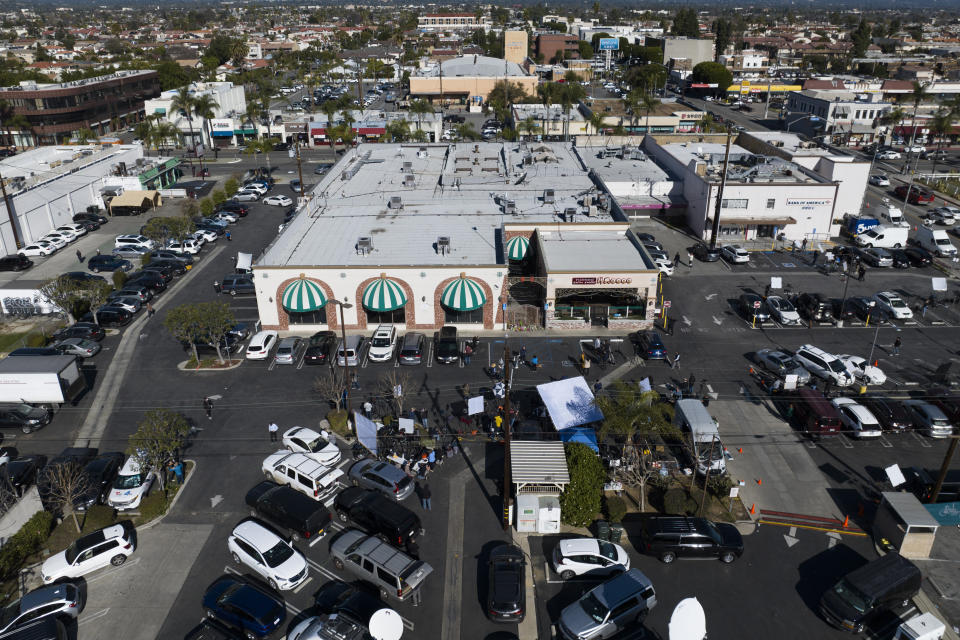 Members of the media are stationed in a parking lot outside Star Ballroom Dance Studio in Monterey Park, Calif., Monday, Jan. 23, 2023. Authorities searched for a motive for the gunman who killed multiple people at the ballroom dance studio during Lunar New Year celebrations, slayings that sent a wave of fear through Asian American communities and cast a shadow over festivities nationwide. (AP Photo/Jae C. Hong)