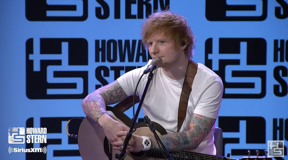 Ed on the Howard Stern Show holding his guitar