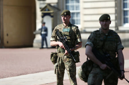 Armed soldiers stand outside Buckingham Palace in London, Britain May 25, 2017. REUTERS/Neil Hall