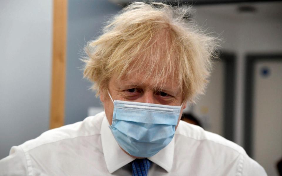 Boris Johnson looks on during a visit to a coronavirus vaccination centre at the Health and Well-being Centre in Orpington - Pool