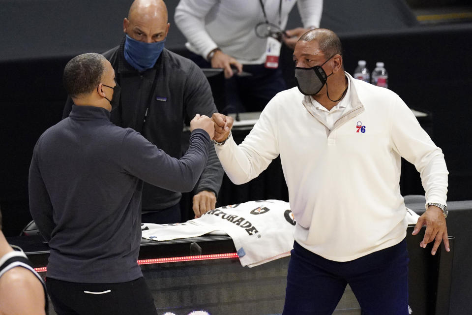 Los Angeles Clippers head coach Tyronn Lue, left, and Philadelphia 76ers head coach Doc Rivers greet each other after their NBA basketball game Saturday, March 27, 2021, in Los Angeles. The Clippers won 122-112. (AP Photo/Mark J. Terrill)