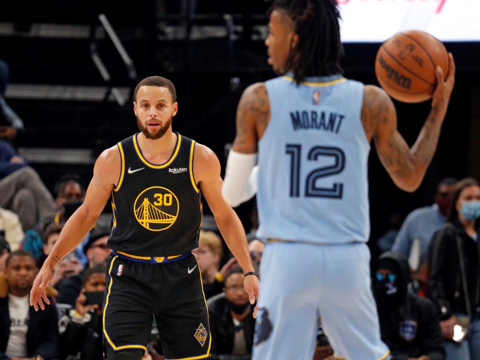 Warriors guard Stephen Curry (30) watches as Memphis Grizzles guard Ja Morant (12) brings the ball up the court during the first half at FedExForum.