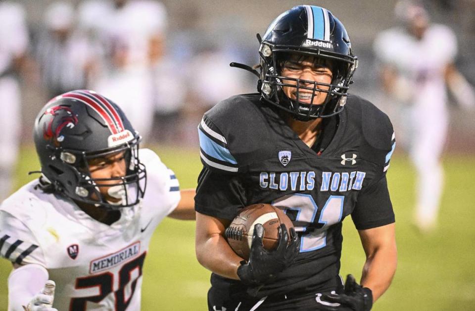 Clovis North’s Kyle Kobashi, right, tries to break away from Memorial’s Cameron Smith on a short pass play during their game at Veterans Memorial Stadium in Clovis on Friday, Aug. 18, 2023.