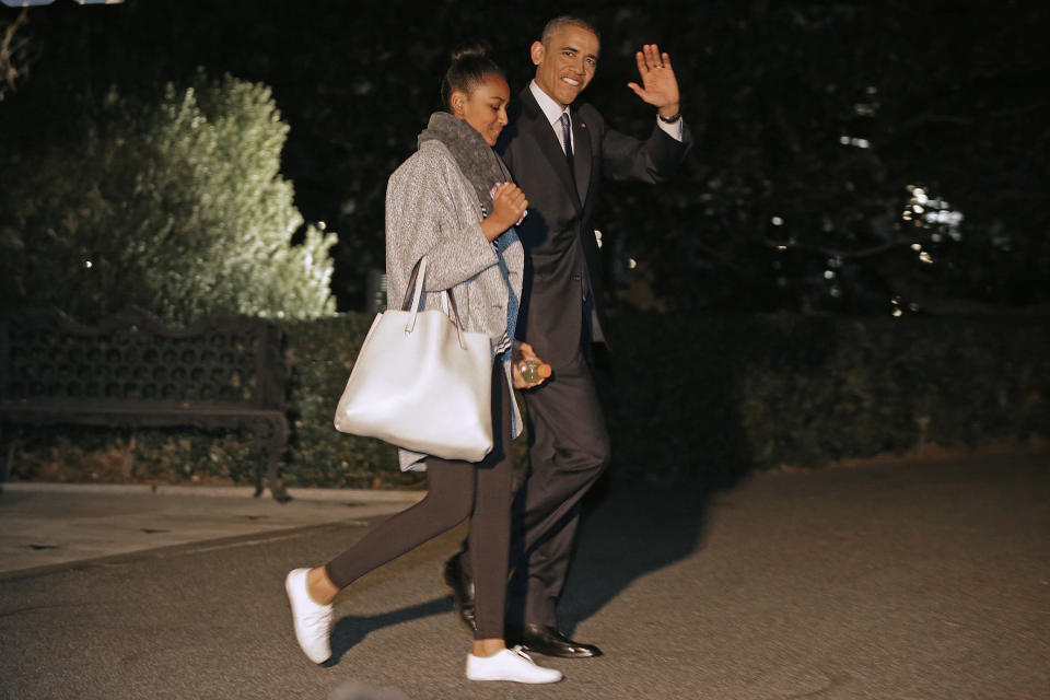 President Barack Obama and his daughter Sasha Obama leave the White House for their holiday vacation December 19, 2014, in Washington.