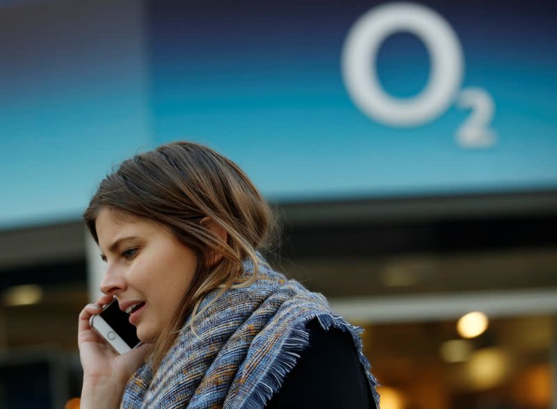 FILE PHOTO: A woman speaks on a mobile telephone outside an O2 store in central London