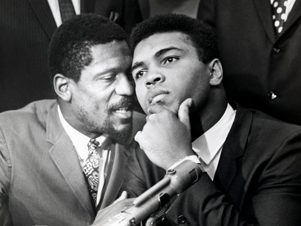 Professional basketball player Bill Russell, left, speaks with boxer Muhammad Ali during a news conference of top African-American athletes in support of Ali's refusal to fight in Vietnam on June 4, 1967, in Cleveland.