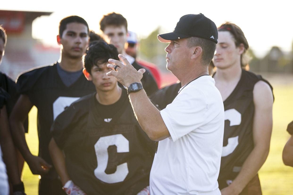 Coach Shane Hedrick talks to players at a Central High School football practice on Tuesday, Aug. 22, 2017.