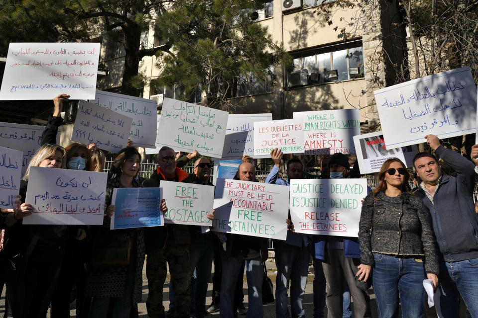 Families of detainees in the Aug. 4, 2020 Beirut port blast investigation hold placards during a protest in front of the Justice Palace in Beirut, Lebanon, Jan. 19, 2023. The judge Tarek Bitar investigating Beirut's massive 2020 port blast resumed work Monday, Jan. 23, 2023 after a nearly 13-month halt, ordering the release of some detainees and announcing plans to charge others, including two top generals, judicial officials said. (AP Photo/Bilal Hussein)