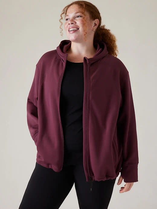 model wearing burgundy running jacket with black top