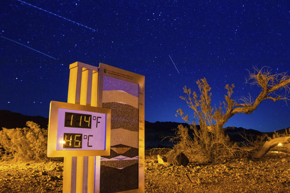 A long exposure image of the thermostat at the Furnace Creek Visitors Center taken just after 10:00 p.m., in Death Valley National Park, Calif., Sunday, July 7, 2024. Forecasters say a heat wave could break previous records across the U.S., including in Death Valley. (AP Photo/Ty ONeil)