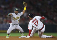 Oakland Athletics second baseman Tony Kemp holds up the ball after tagging out Los Angeles Angels' Shohei Ohtani on an attempted steal during the sixth inning of a baseball game Friday, July 30, 2021, in Anaheim, Calif. (AP Photo/John McCoy)