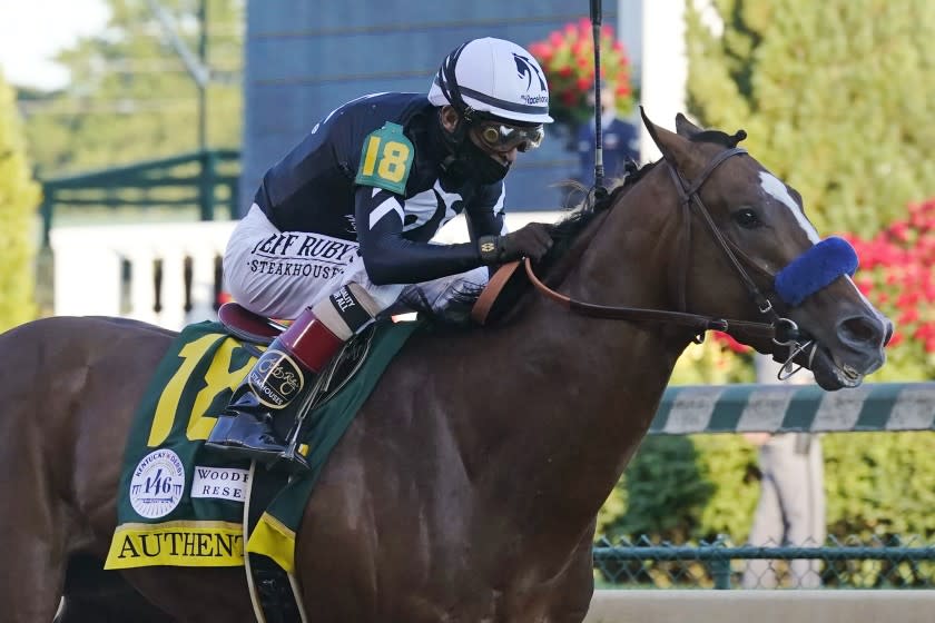 FILE - In this Saturday, Sept. 5, 2020, file photo, Authentic, ridden by jockey John Velazquez, heads to the finish line to win the 146th running of the Kentucky Derby at Churchill Downs in Louisville, Ky. The Kentucky Derby winner is the morning line favorite at 9-5, and drew the No. 9 post in a field of 11 horses for Saturday's Preakness Stakes. (AP Photo/Darron Cummings, File)