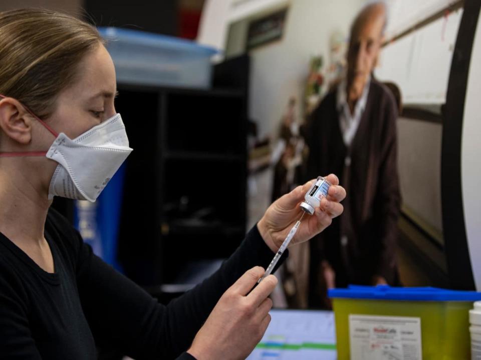 Family doctor Christa Sinclair Mills fills doses of COVID-19 vaccine. (Evan Mitsui/CBC - image credit)