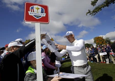 Danny Willett of England signs autographs on the fourth green during a practice round for the 41st Ryder Cup at Hazeltine National Golf Club. Mandatory Credit: Rob Schumacher-USA TODAY Sports