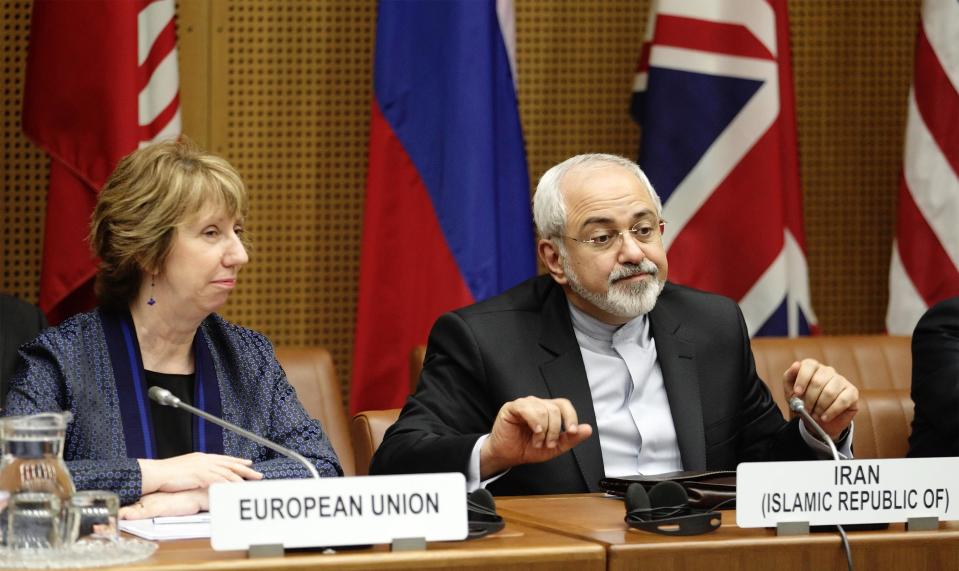 European Union Foreign Policy Chief Catherine Ashton (L) and Iranian Foreign Minister Mohammad Javad Zarif wait for the begin of talks in Vienna June 17, 2014. Six world powers and Iran began their fifth round of nuclear negotiations on Tuesday in hopes of salvaging prospects for a deal over Tehran's disputed atomic activity by a July deadline. REUTERS/Heinz-Peter Bader (AUSTRIA - Tags: POLITICS ENERGY)