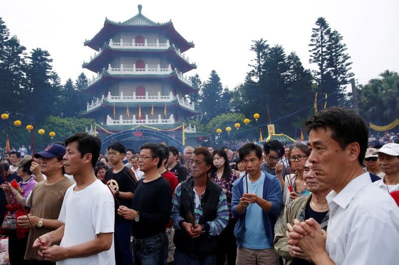 FILE PHOTO: Thousands of people attend an annual worship ceremony to pay respect to their ancestors on Qingming Festival, also known as Tomb Sweeping Day, in Taoyuan, Taiwan