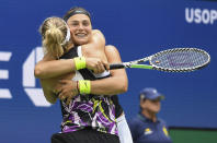 Arena Sabalenka, of Belarus, right, celebrates with doubles partner Elise Mertens, of Belgium, after winning the women's doubles final against Victoria Azarenka, of Belarus, and Ashleigh Barty, of Australia, at the U.S. Open tennis championships Sunday, Sept. 8, 2019, in New York. (AP Photo/Sarah Stier)