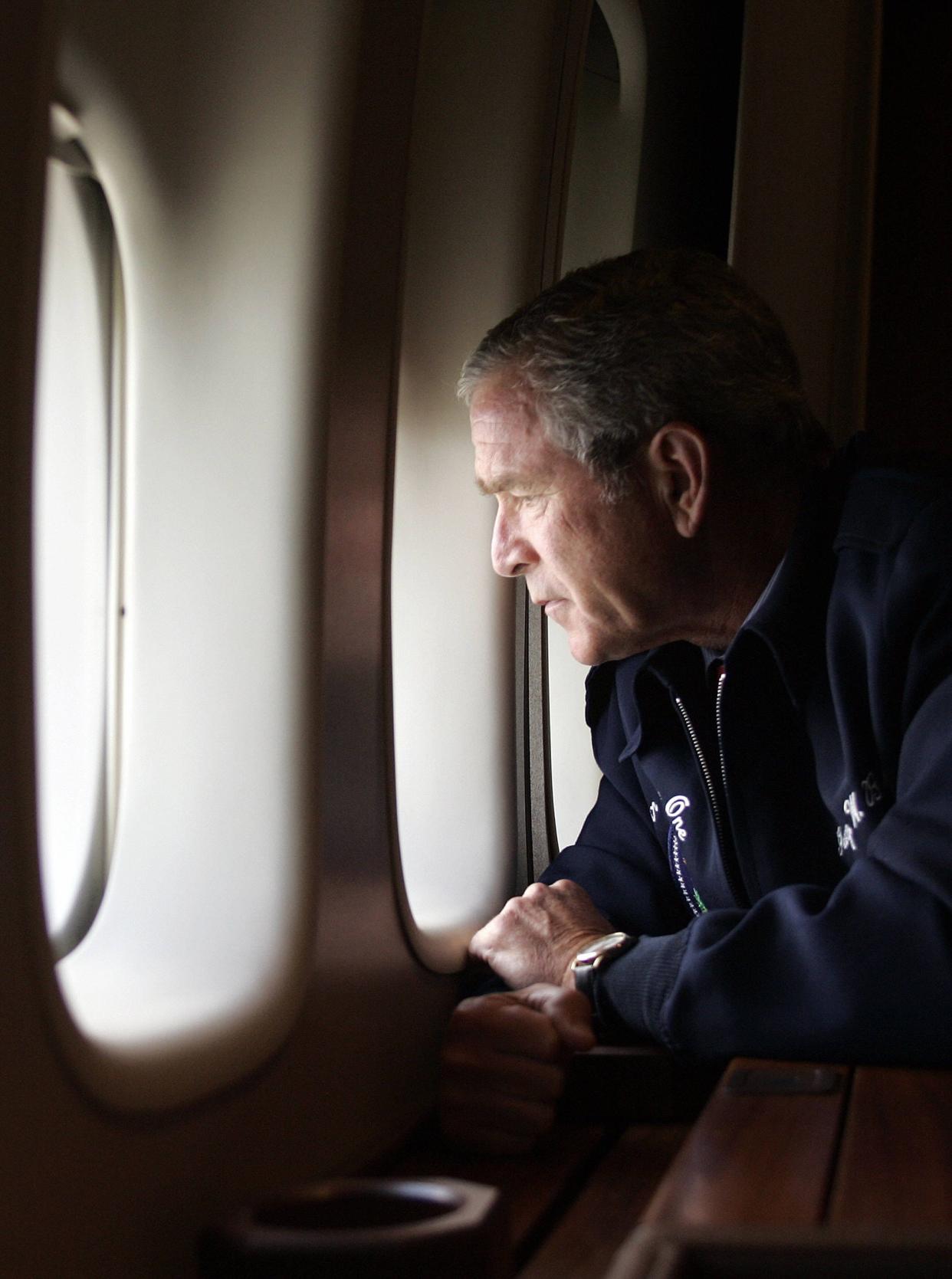 President George W. Bush looks out the window of Air Force One on Aug. 31, 2005, as he flies over New Orleans, Louisiana, surveying the damage left by Hurricane Katrina.