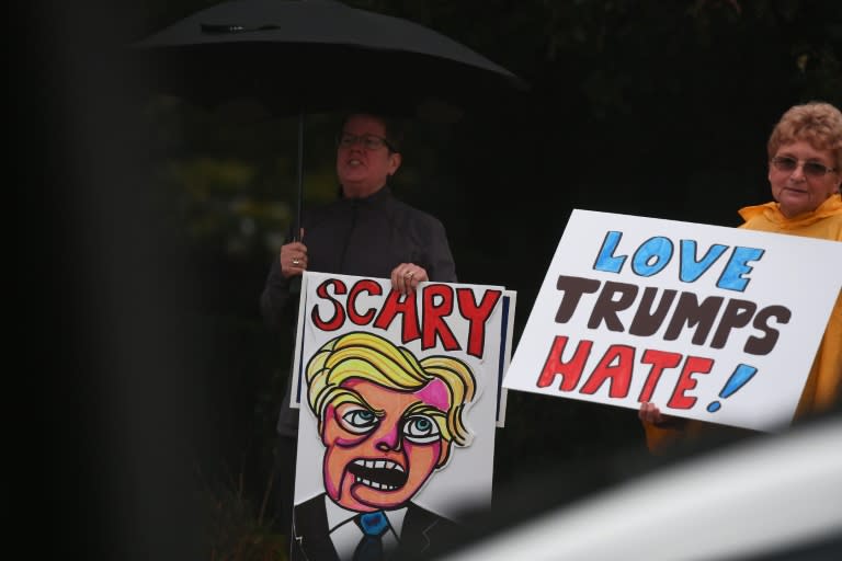 Protesters gather outside the Suburban Collection Showplace in Novi, Michigan, on September 30, 2016, during a campaign rally by US Republican presidential nominee Donald Trump