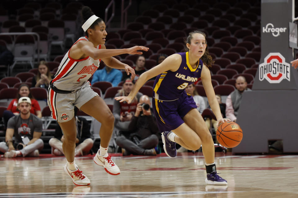 Albany's Lilly Phillips, right, brings the ball upcourt as Ohio State's Taylor Thierry defends during the first half of an NCAA college basketball game on Friday, Dec. 16, 2022, in Columbus, Ohio. (AP Photo/Jay LaPrete)