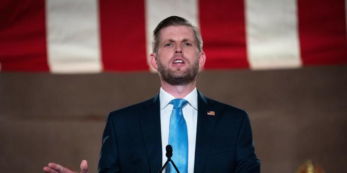 Eric Trump stands on a podium.