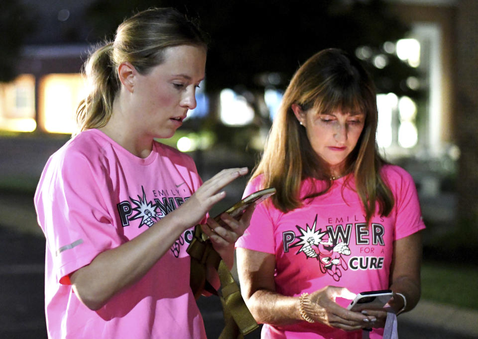 From left, event organizer Jenny Fogo and Wendy Ransom confer on the routeat Girls Preparatory School, for "Finish Eliza's Run" on Friday, Sept. 9, 2022 in Chattanooga, Tenn. The approximately four mile run was to memorialize, Eliza Fletcher, the Memphis runner, and mother of two, who was murdered during her early morning run. (Robin Rudd /Chattanooga Times Free Press via AP)