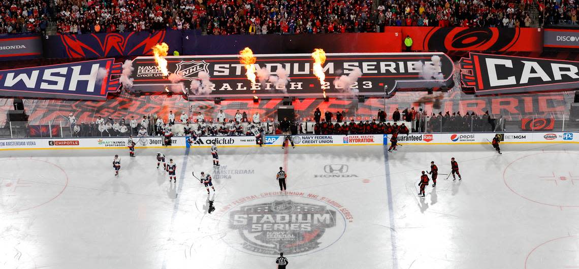 Pyrotechnics go off to celebrate after Carolina’s Jesperi Kotkaniemi (82) scored during the first period of the NHL Stadium Series game between the Carolina Hurricanes and the Washington Capitals at Carter-Finley Stadium in Raleigh, N.C., Saturday, Feb. 18, 2023.