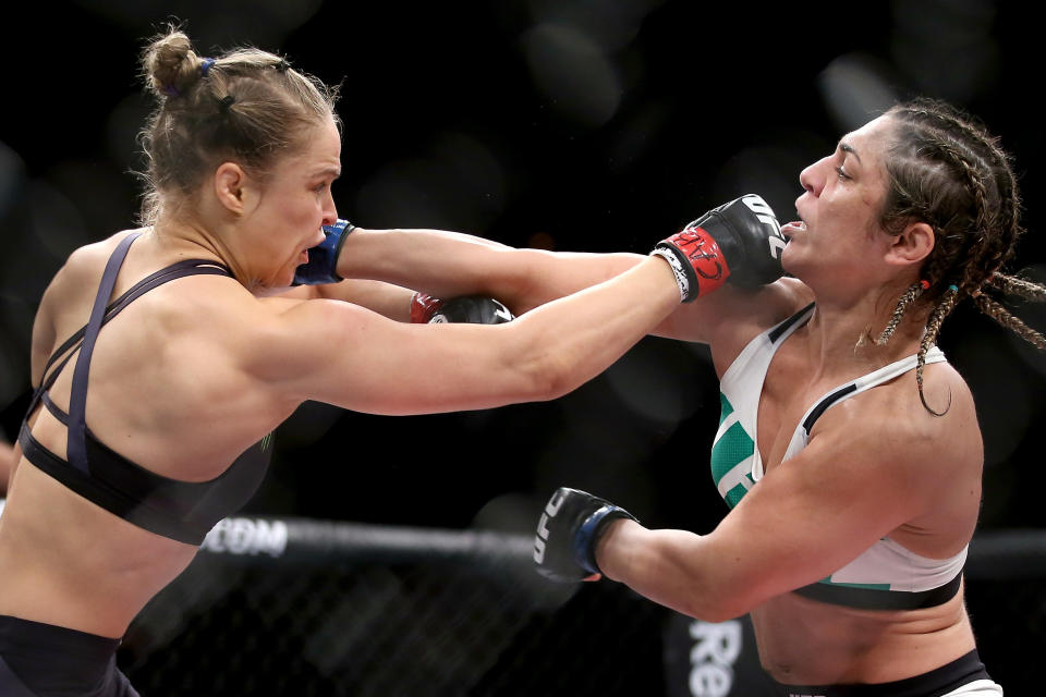 RIO DE JANEIRO, BRAZIL - AUGUST 01:  Ronda Rousey of the United States (red) fights Bethe Correia of Brazi (blue) l in their bantamweight title fight during the UFC 190 Rousey v Correia at HSBC Arena on August 1, 2015 in Rio de Janeiro, Brazil.  (Photo by Matthew Stockman/Getty Images)