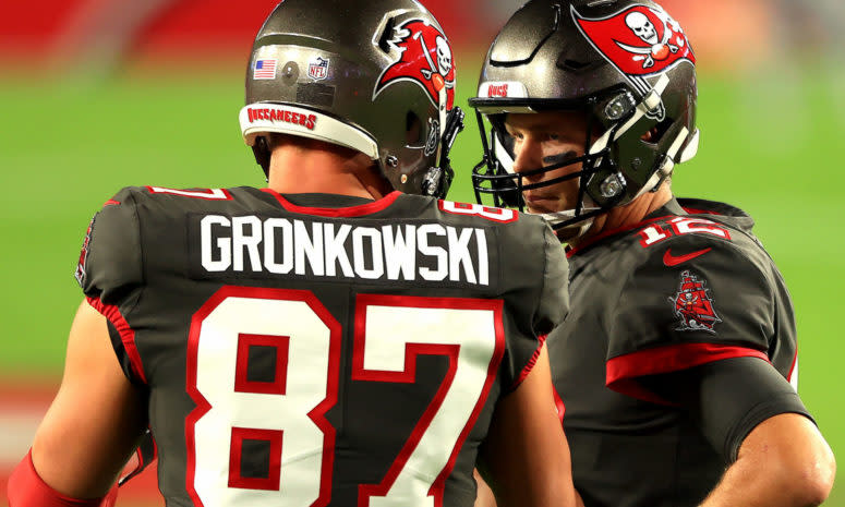 Rob Gronkowski #87 and Tom Brady #12 of the Tampa Bay Buccaneers talk prior to a game