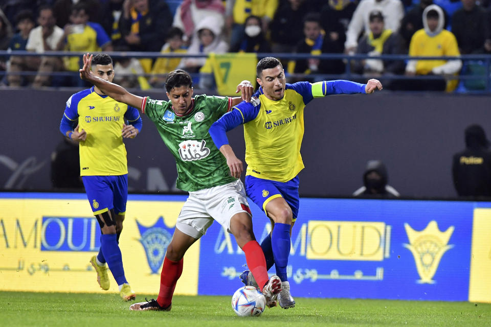 FILE - Al Nassr's Cristiano Ronaldo, right, fights for the ball during the Saudi Pro League match between Al Ettifaq FC and Al Nassr FC at Mrsool Park Stadium, in Riyadh, Saudi Arabia, Jan. 22, 2023. The Saudi Arabian soccer league kicks off Friday Aug. 11, 2023 after a spending spree on players grabbed the world’s attention in the European summer offseason. Now the actual games start and the appeal of watching newly recruited Champions League winners like Karim Benzema, Sadio Mane and Riyad Mahrez — who have followed the January trailblazer Cristiano Ronaldo into unfamiliar surroundings — will be tested. (AP Photo/File)
