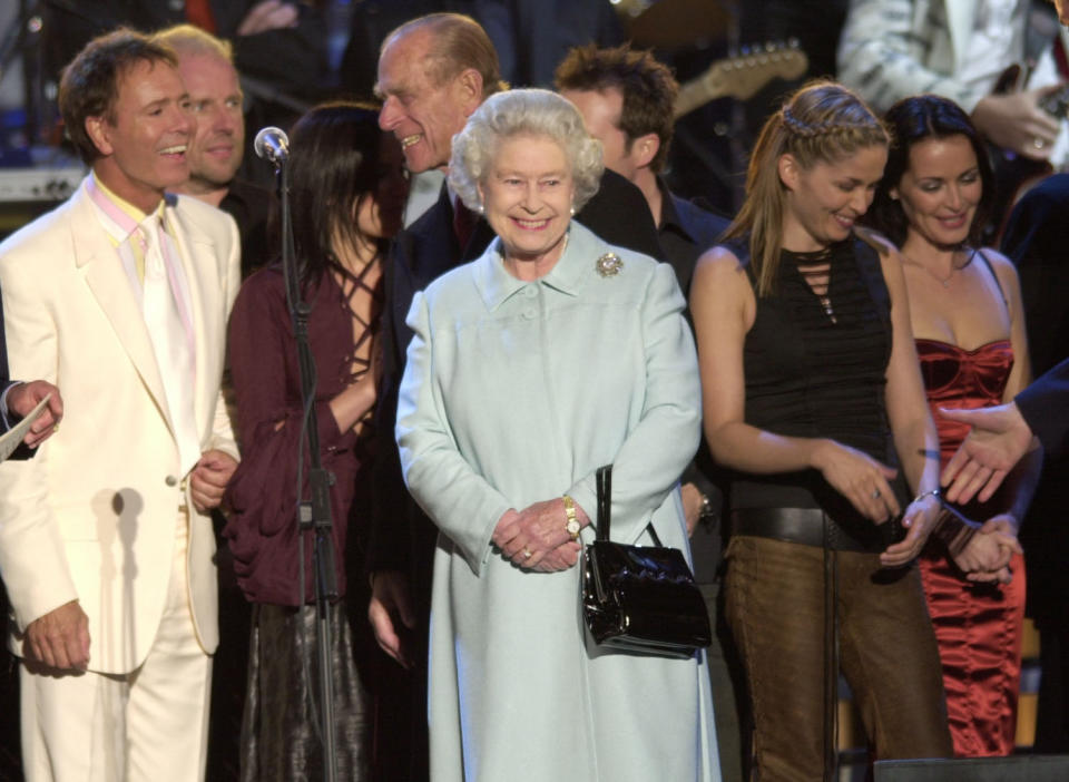 Britain's Queen Elizabeth II meets artist on stage in the gardens of Buckingham Palace,  after the second concert to commemorate the Golden Jubilee of Britain's Queen Elizabeth II.    * Some 12,000 tickets were distributed by ballot for the Party at the Palace, and ten of thousands more gathered outside to enjoy the music.  Later The Queen was lighting a beacon and watching a firework display.  On Tuesday she will travel to the St Paul's for a service of thanksgiving.   (Photo by Stefan Rousseau - PA Images/PA Images via Getty Images)