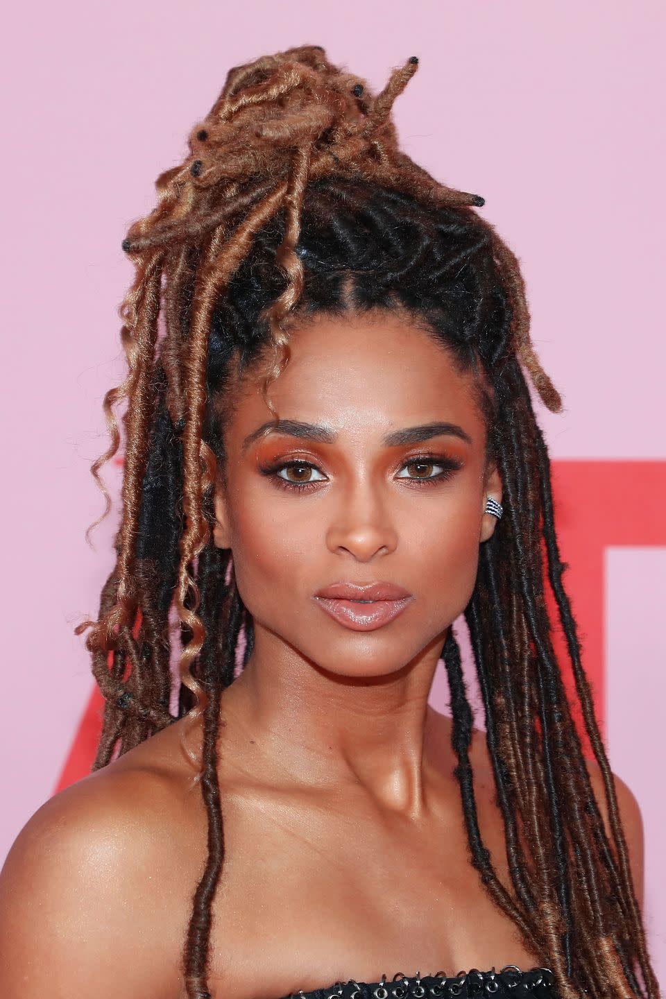 <p>Ask your hairstylist to leave some curly pieces on the ends of your long dreadlocks, as you see here on singer Ciara.</p>