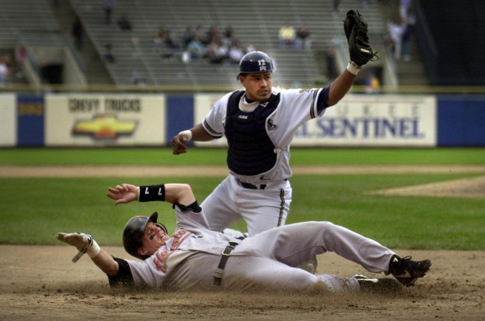 Milwaukee Brewer catcher Henry Blanco tags out Houston's Biggio at home plate during the fifth inning, May 22nd, 2000, in Game 1 of a doubleheader at Milwaukee County Stadium. That kept Houston's lead at 4-2 at the time and would loom large when the Brewers rallied for seven runs in the ninth to tie, then win in extras.