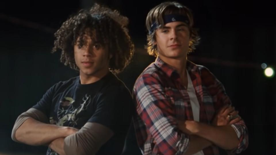 Chad and Tory standing back to back in The Boys Are Back during High School Musical 3.