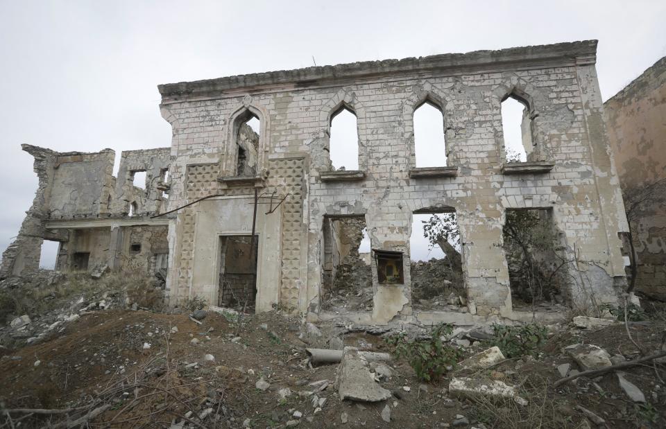 FILE - In this Friday, Nov. 20, 2020 file photo, a view of a vast expanse of jagged concrete and houses reduced to shells in Aghdam, after the Azerbaijani forces handed control that had been occupied by Armenian forces for a quarter-century, Aghdam, Azerbaijan. With Azerbaijan regaining control of land it lost to Armenian forces a quarter-century ago, civilians who fled the fighting decades ago are wondering if they can go back home now. But as Azerbaijani forces discovered when the first area was turned over Friday, Nov. 20 much of the recovered land is uninhabitable. (AP Photo/Sergei Grits, file)