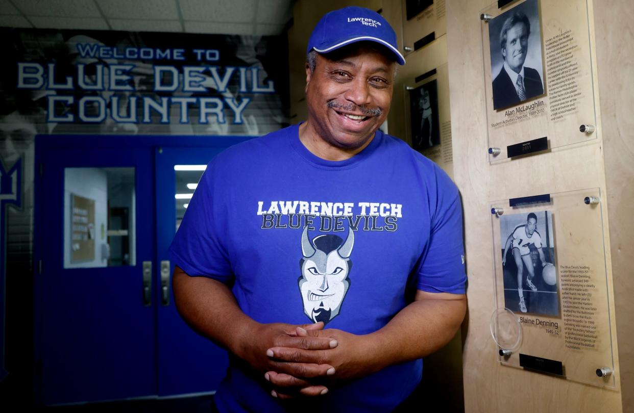 Blaine Denning Jr. stands next to a picture of his father, Blaine Denning Sr., on Wednesday, Feb. 21, 2024. Denning is in the Lawrence Technological University Athletic Hall of Fame and is honored with his picture on the Wall of Fame inside of the Don Ridler Field House.