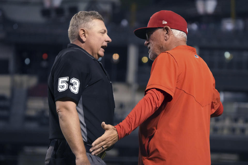 Los Angeles Angels manager Joe Maddon talks to umpire Greg Gibson after Shohei Ohtani was called for his second balk of the night, in the fifth inning of the team's baseball game against the Arizona Diamondbacks, Friday, June 11, 2021, in Phoenix. (AP Photo/Rick Scuteri)