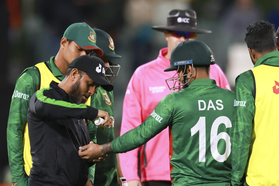 Bangladesh's Litton Das receives treatment to an injured hand during the T20 World Cup cricket match between India and Bangladesh in Adelaide, Australia, Wednesday, Nov. 2, 2022. (AP Photo/James Elsby)