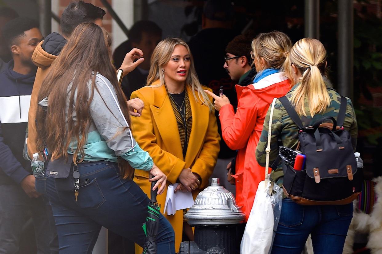 Hilary Duff gets her hair and makeup touched up while on the set of the "Lizzie McGuire" Disney+ reboot in Washington Square Park on Oct. 29, 2019, in New York City.