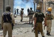 <p>Kashmiri protestors clash with Indian police in Srinagar on July 10, 2016. The death toll from unrest in Indian-administered Kashmir climbed to 15 July 10, officials said, despite authorities imposing a harsher curfew on the restive territory in a bid to prevent new demonstrations. One protestor was killed on July 10 when government forces fired on angry residents who defied the restrictions in the southern Pulwama area, and six died in different hospitals overnight after suffering gunshot wounds on July 9, a police officer said, speaking on condition of anonymity. </p>