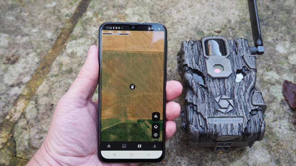 iPhone with image on the screen being held next to a Stealth Cam Fusion Global