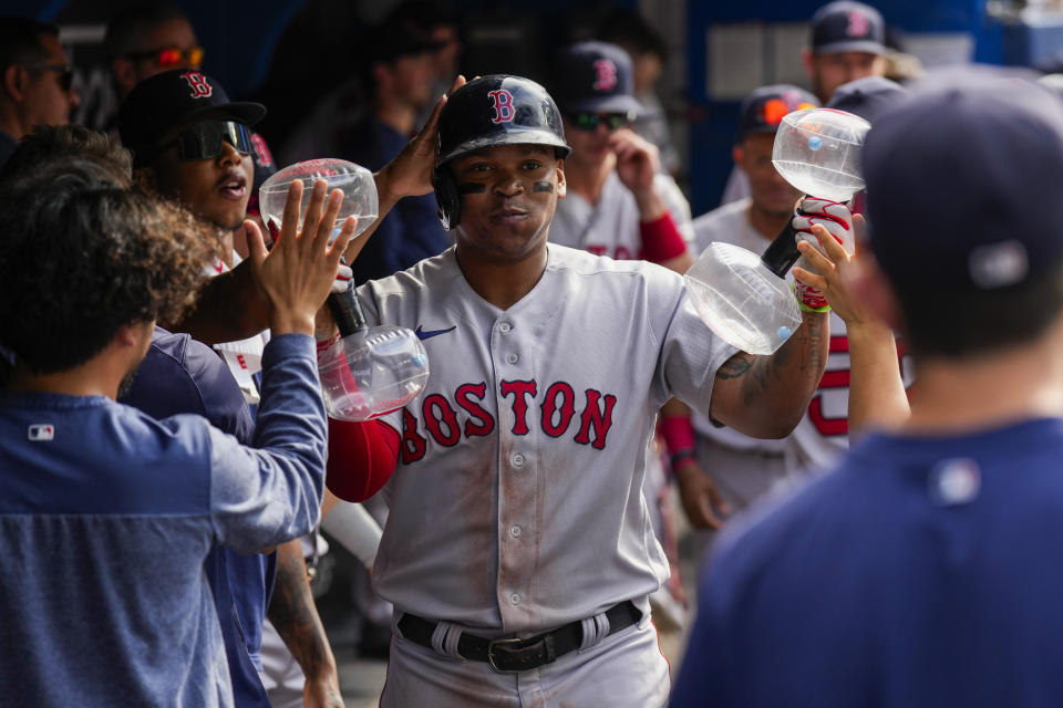 Boston Red Sox's Rafael Devers (11) celebrates his home run against the Toronto Blue Jays during the ninth inning of a baseball game in Toronto, Sunday, Sept. 17, 2023. (Andrew Lahodynskyj/The Canadian Press via AP)