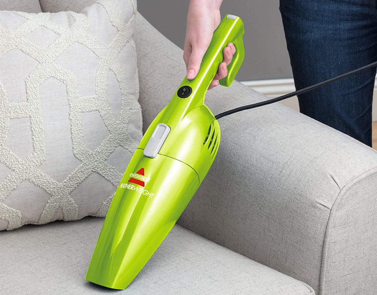 The detachable handheld vac cleaning a couch