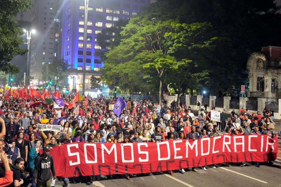Demonstrators march holding a banner that reads in Portuguese "We are Democracy" during a protest calling for protection of the nation's democracy in Sao Paulo, Brazil, Monday, Jan. 9, 2023, a day after supporters of former President Jair Bolsonaro stormed government buildings in the capital.
