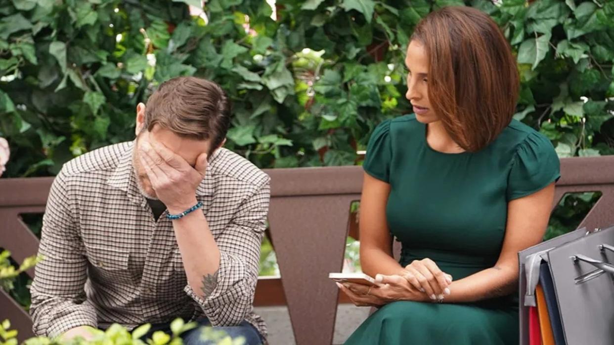  Michael Graziadei and Christel Khalil as Daniel and Lily on a park bench in The Young and the Restless. 