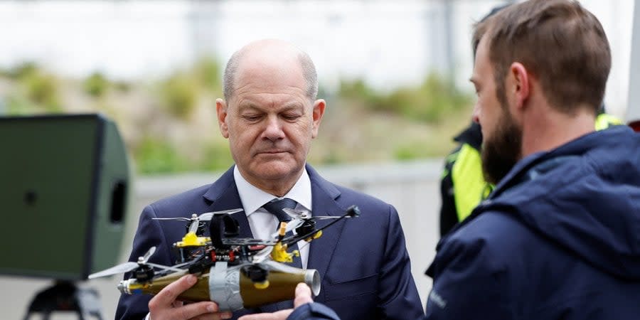 German Chancellor holds a UAV during his visit to Federal Police Department in Wisbaden on April 25