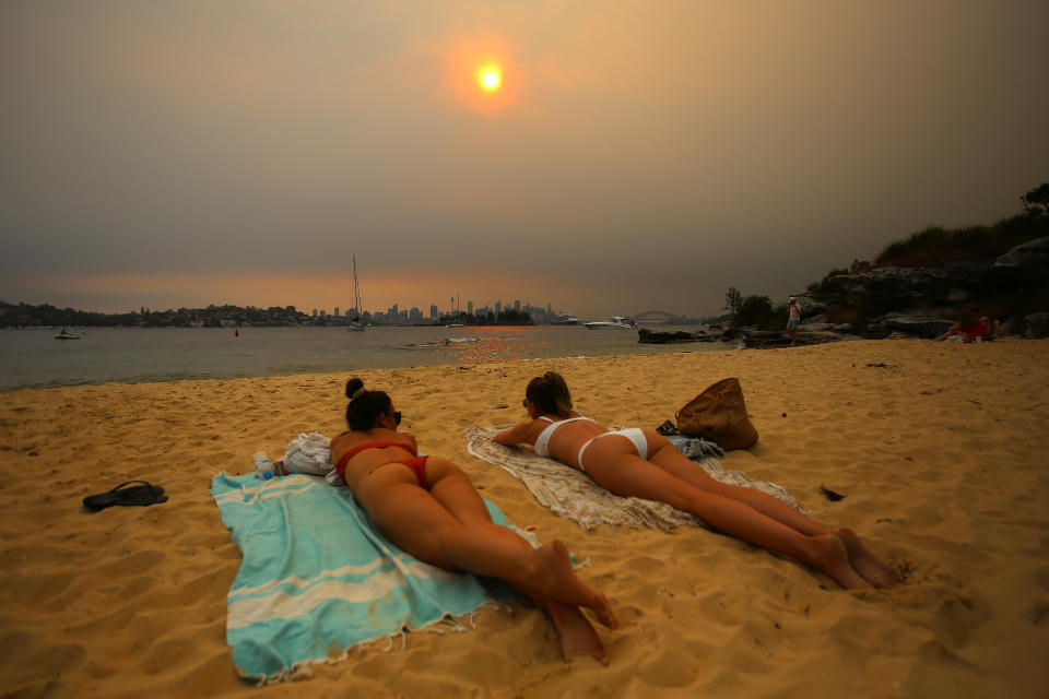 Two sunbathers in bikinis on Milk Beach in Vaucluse on Saturday. Source: AAP