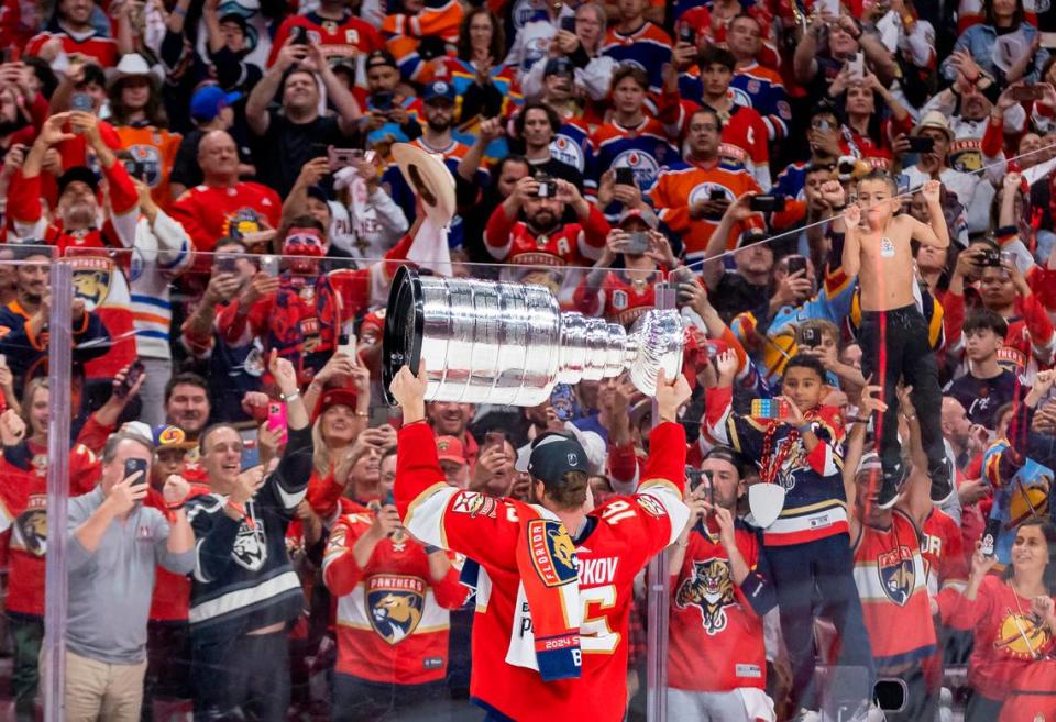 Florida Panthers center Aleksander Barkov (16) holds the Stanley Cup as fans cheer after The Florida Panthers defeated the Edmonton Oilers in Game 7 of the Stanley Cup Final