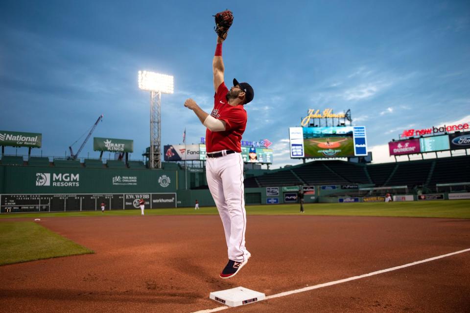<p>Mitch Moreland #18 of the Boston Red Sox leaps to catch a ball before an exhibition game against the Toronto Blue Jays before the start of the 2020 MLB season on July 22 at Fenway Park.</p>