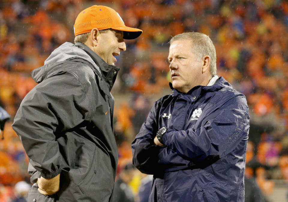 Clemson coach Dabo Swinney talks to Notre Dame coach Brian Kelly before a game during the 2015 season. (Streeter Lecka/Getty Images)